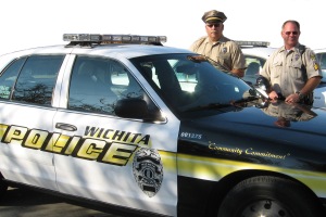 Lt. Schroeder and Sgt. Clark Bolan pose with the Wichita Police Department squad car.